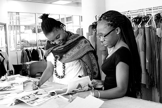 Grey scale Workers looking at book with designs