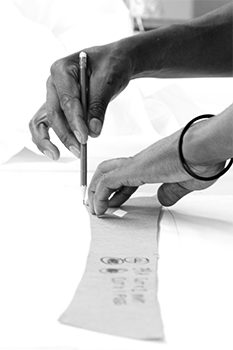 Grey scale workers hands measuring on blank paper